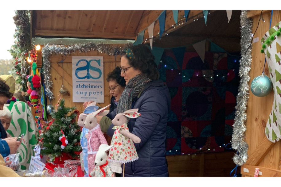 A group of ladies looking at products for sale by Alzheimer's society