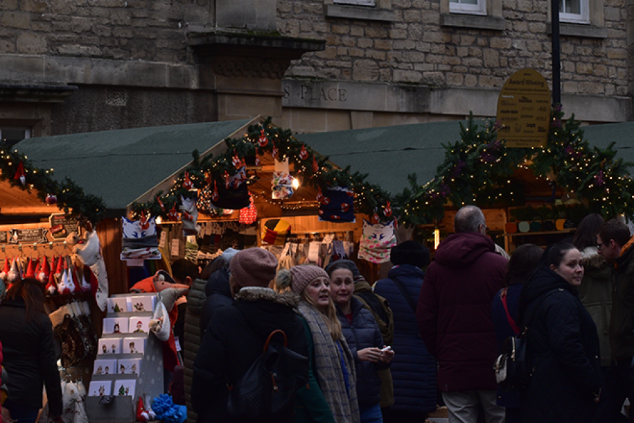 Row of chalets under the twinkling lights of Bath Christmas Market