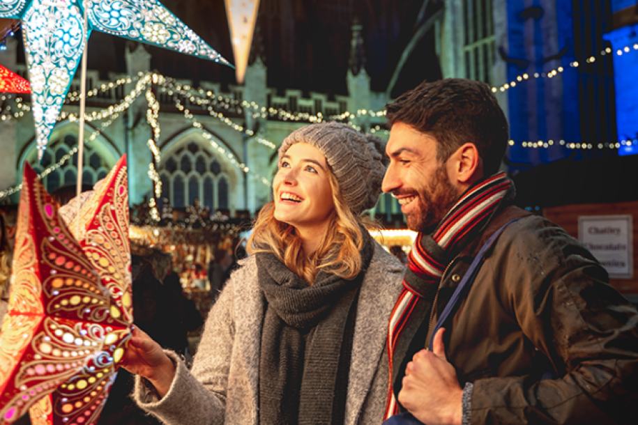 Two people marvelling at a star under the lights of Bath