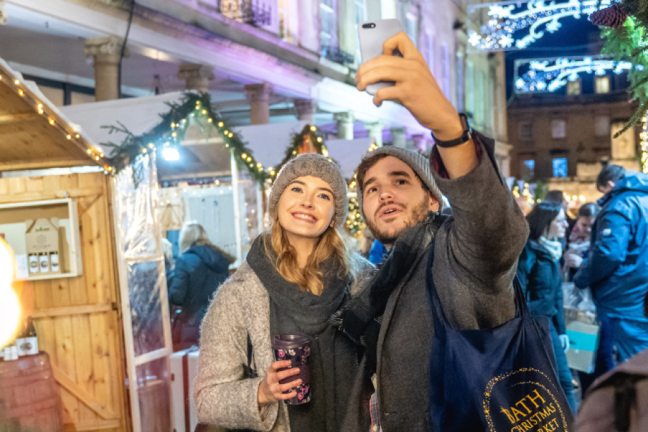 Two people in Bath Christmas Market taking a selfie