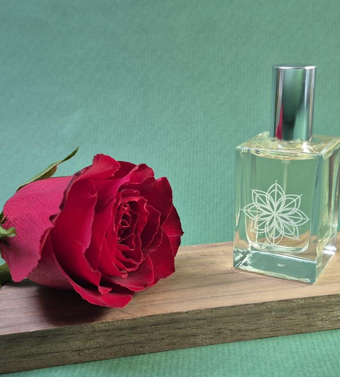 red rose and bottle of perfume