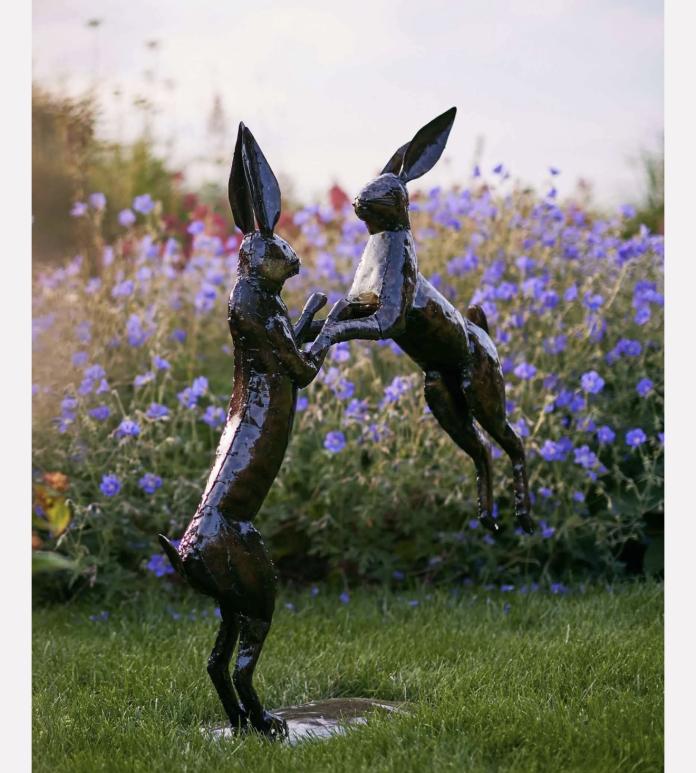 Sculpture of two leaping rabbits.