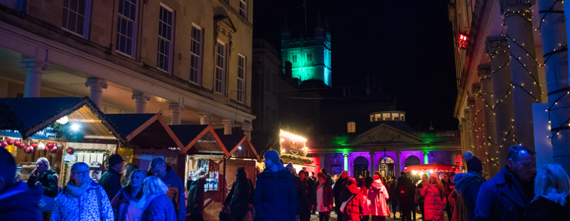 Row of chalets under the twinkling lights of Bath Christmas Market