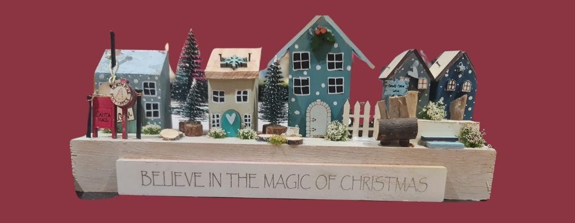 Clay Models of houses with a sign which reads 'Believe in the Magic of Christmas'