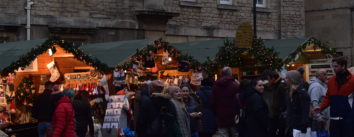 Row of chalets under the twinkling lights of Bath Christmas Market