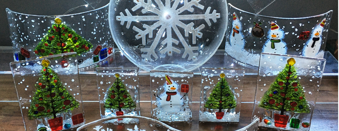 Glass ornamental Christmas trees and a Snowman.