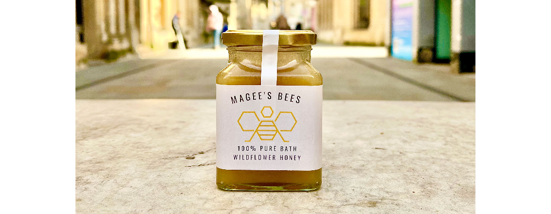 Jar of honey with bee image on label