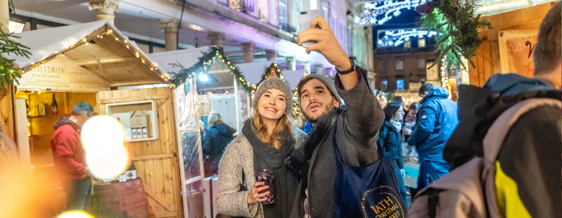 Two people in Bath Christmas Market taking a selfie